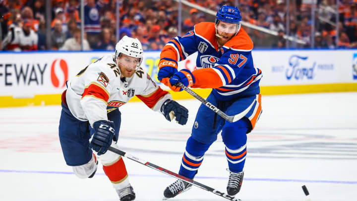 Jun 21, 2024; Edmonton, Alberta, CAN; Florida Panthers defenseman Gustav Forsling (42) and Edmonton Oilers center Connor McDavid (97) battles for the puck during the second period in game six of the 2024 Stanley Cup Final at Rogers Place. Mandatory Credit: Sergei Belski-USA TODAY Sports