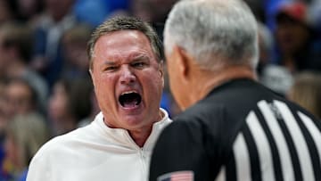 Dec 31, 2024; Lawrence, Kansas, USA; Kansas Jayhawks head coach Bill Self talks to official Randy McCall during the second half against the West Virginia Mountaineers at Allen Fieldhouse. Mandatory Credit: Jay Biggerstaff-Imagn Images
