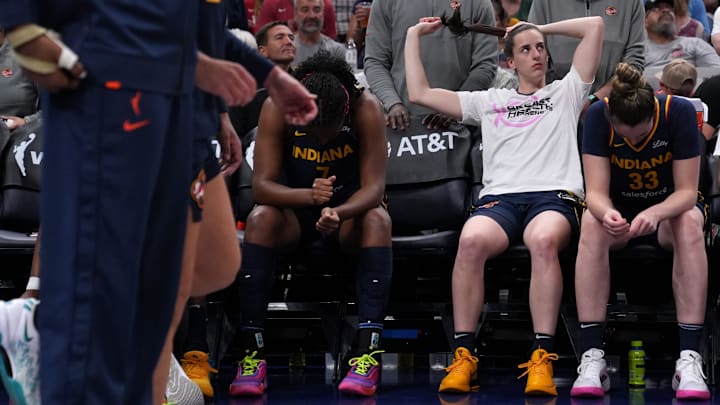 Indiana Fever guard Caitlin Clark (22) ties up her hair before a game against the Seattle Storm on Sunday, Aug. 18, 2024, at Gainbridge Fieldhouse in Indianapolis. The Fever defeated the Storm 92-75.