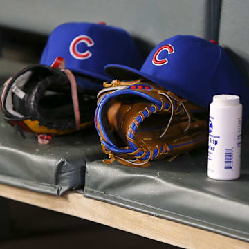 Apr 3, 2019; Atlanta, GA, USA; Detailed view of Chicago Cubs hats and gloves in the dugout against the Atlanta Braves in the fifth inning at SunTrust Park.