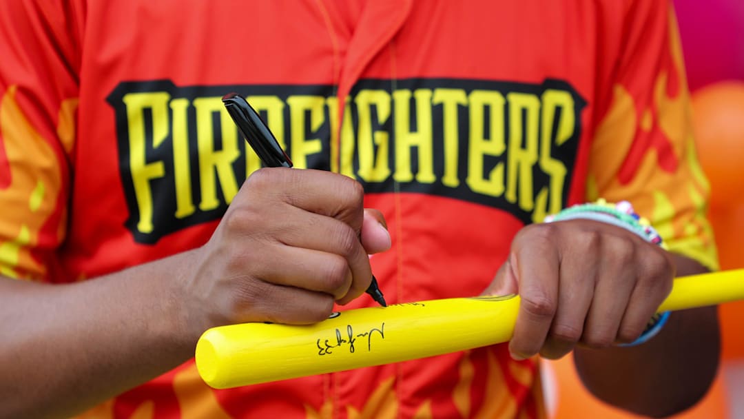 Firefighters player Ga'von Wray autographs a bat during a Banana Ball takeover at Dunkin' Donuts on Saturday, August 23, 2025 in Savannah.