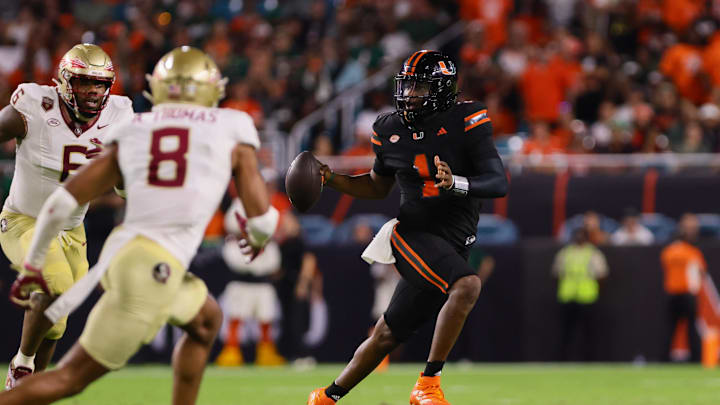 Oct 26, 2024; Miami Gardens, Florida, USA; Miami Hurricanes quarterback Cam Ward (1) runs with the football against the Florida State Seminoles during the third quarter at Hard Rock Stadium. Mandatory Credit: Sam Navarro-Imagn Images