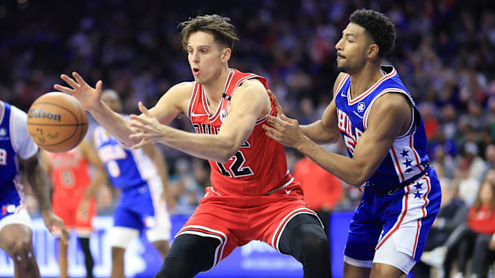 Feb 24, 2025; Philadelphia, Pennsylvania, USA; Chicago Bulls forward Zach Collins (12) catches a pass in front of Philadelphia 76ers guard Quentin Grimes (5) during the third quarter at Wells Fargo Center. Mandatory Credit: Bill Streicher-Imagn Images