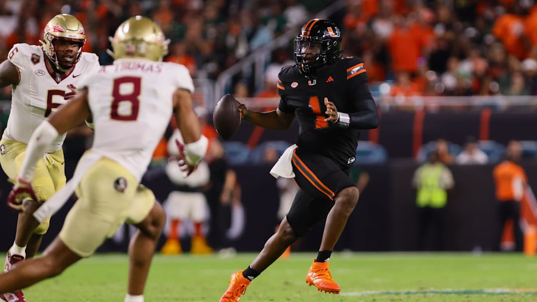 Oct 26, 2024; Miami Gardens, Florida, USA; Miami Hurricanes quarterback Cam Ward (1) runs with the football against the Florida State Seminoles during the third quarter at Hard Rock Stadium. Mandatory Credit: Sam Navarro-Imagn Images