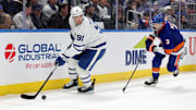 Jan 2, 2025; Elmont, New York, USA; Toronto Maple Leafs center John Tavares (91) controls the puck against New York Islanders defenseman Adam Pelech (3) during the third period at UBS Arena. Mandatory Credit: Brad Penner-Imagn Images