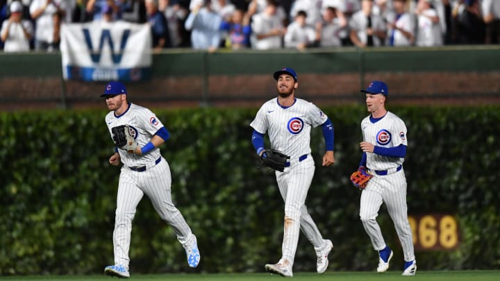 Aug 20, 2024; Chicago, Illinois, USA; Chicago Cubs left fielder Ian Happ (left), right fielder Cody Bellinger (center), and center fielder Pete Crow-Armstrong (right) celebrate after defeating the Detroit Tigers at Wrigley Field.