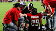 Sep 27, 2025; Raleigh, North Carolina, USA;  North Carolina State Wolfpack safety Brody Barnhardt (29) is injured and taken off the field during the first half of the game against Virginia Tech Hokies at Carter-Finley Stadium. Mandatory Credit: Jaylynn Nash-Imagn Images