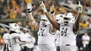 Sep 2, 2023; Waco, Texas, USA; Texas State Bobcats offensive lineman Caleb Johnson (74) and offensive lineman Dorion Strawn (64) celebrate a touchdown against the Baylor Bears during the second half at McLane Stadium. Mandatory Credit: Raymond Carlin III-Imagn Images
