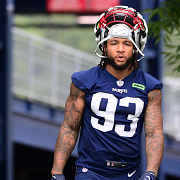 Jul 24, 2024; Foxborough, MA, USA; New England Patriots linebacker Oshane Ximines (93) walks to the practice field during training camp at Gillette Stadium. Mandatory Credit: Eric Canha-Imagn Images