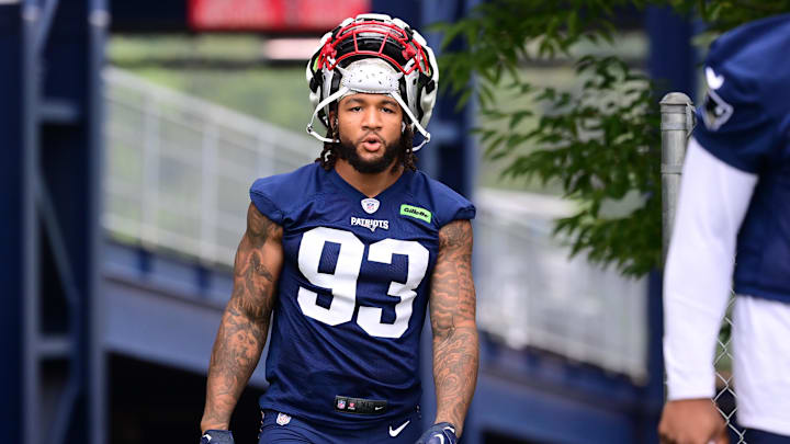 Jul 24, 2024; Foxborough, MA, USA; New England Patriots linebacker Oshane Ximines (93) walks to the practice field during training camp at Gillette Stadium. Mandatory Credit: Eric Canha-Imagn Images