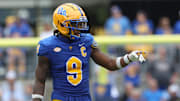 Sep 27, 2025; Pittsburgh, Pennsylvania, USA;  Pittsburgh Panthers linebacker Kyle Louis (9) gestures at the line of scrimmage against the Louisville Cardinals during the second quarter at Acrisure Stadium. Mandatory Credit: Charles LeClaire-Imagn Images