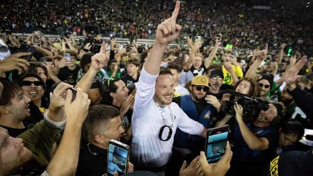 oach Dan Lanning celebrates amid a crowd of fans on the field as No. 3 Oregon knocked off No. 2 Ohio State 32-31