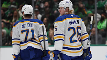 Dec 31, 2024; Dallas, Texas, USA; Buffalo Sabres defenseman Rasmus Dahlin (26) talks to center Ryan McLeod (71) during a stoppage in play against the Dallas Stars at American Airlines Center. Mandatory Credit: Tim Heitman-Imagn Images