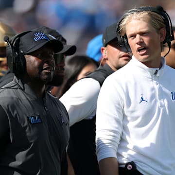 Oct 4, 2025; Pasadena, California, USA;  UCLA Bruins interim head coach Tim Skipper (left) and  new offensive coordinator Jerry Neuheisel (right) on the sideline during second half against the Penn State Nittany Lions at Rose Bowl. Mandatory Credit: Kiyoshi Mio-Imagn Images