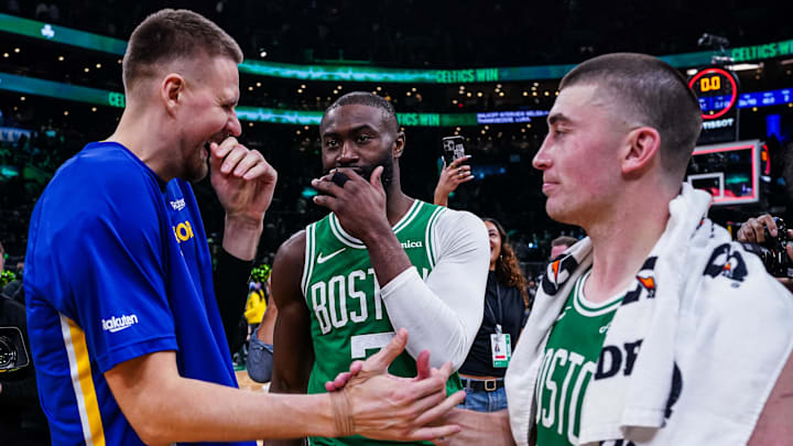 Mar 18, 2026; Boston, Massachusetts, USA; Boston Celtics guard Jaylen Brown (7) and guard Payton Pritchard (11) talk with Golden State Warriors center Kristaps Porzingis (7) after the game at TD Garden. Mandatory Credit: David Butler II-Imagn Images