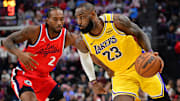 Feb 4, 2025; Inglewood, California, USA; Los Angeles Lakers forward LeBron James (23) moves the ball against Los Angeles Clippers forward Kawhi Leonard (2) during the second half at Intuit Dome. Mandatory Credit: Gary A. Vasquez-Imagn Images