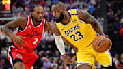 Feb 4, 2025; Inglewood, California, USA; Los Angeles Lakers forward LeBron James (23) moves the ball against Los Angeles Clippers forward Kawhi Leonard (2) during the second half at Intuit Dome. Mandatory Credit: Gary A. Vasquez-Imagn Images