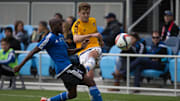 Feb 28, 2015; San Jose, CA, USA; Los Angeles Galaxy midfielder Robbie Rogers (14) kicks the ball against San Jose Earthquakes midfielder Sanna Nyassi (17) during the second half of the preseason game at Avaya Stadium. The San Jose Earthquakes defeated the Los Angeles Galaxy 3-2. Mandatory Credit: Kelley L Cox-Imagn Images