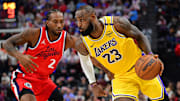 Feb 4, 2025; Inglewood, California, USA; Los Angeles Lakers forward LeBron James (23) moves the ball against Los Angeles Clippers forward Kawhi Leonard (2) during the second half at Intuit Dome. Mandatory Credit: Gary A. Vasquez-Imagn Images