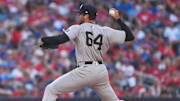 Jul 1, 2025; Toronto, Ontario, CAN; New York Yankees relief pitcher Geoff Hartlieb (64) throws a pitch against the Toronto Blue Jays during the eighth inning at Rogers Centre. Mandatory Credit: Nick Turchiaro-Imagn Images