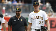 Jul 8, 2024; Pittsburgh, Pennsylvania, USA;  Pittsburgh Pirates pitching coach Oscar Marin (47) and starting pitcher Mitch Keller (23) walk in from the bullpen to play the New York Mets at PNC Park. Mandatory Credit: Charles LeClaire-Imagn Images