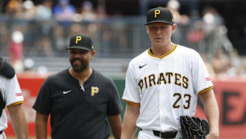Jul 8, 2024; Pittsburgh, Pennsylvania, USA;  Pittsburgh Pirates pitching coach Oscar Marin (47) and starting pitcher Mitch Keller (23) walk in from the bullpen to play the New York Mets at PNC Park. Mandatory Credit: Charles LeClaire-Imagn Images