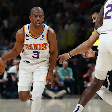 Phoenix Suns guard Chris Paul controls the ball in the first quarter against the Denver Nuggets