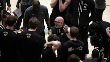 Feb 5, 2025; Stanford, California, USA; Wake Forest Demon Deacons head coach Steve Forbes (center) gestures as he talks to his players during a timeout in the second half against the Stanford Cardinal at Maples Pavilion. Mandatory Credit: D. Ross Cameron-Imagn Images
