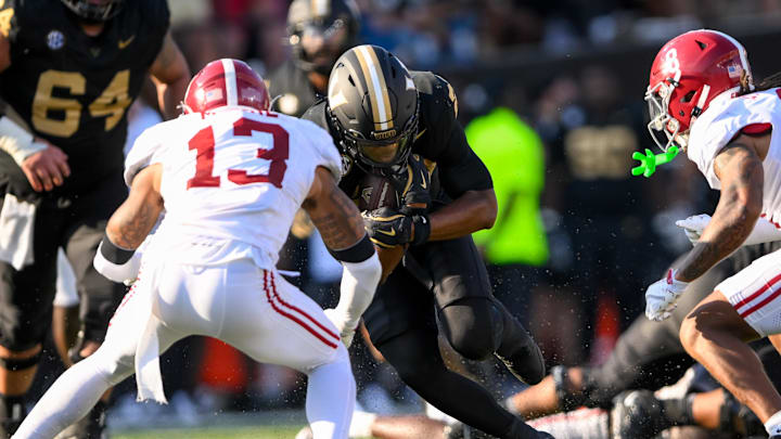 Oct 5, 2024; Nashville, Tennessee, USA;  Alabama Crimson Tide defensive back Malachi Moore (13) tackles Vanderbilt Commodores running back AJ Newberry (23) during the first half at FirstBank Stadium. Mandatory Credit: Steve Roberts-Imagn Images