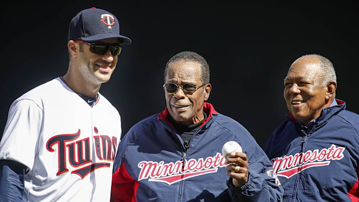 Apr 11, 2016; Minneapolis, MN, USA; Minnesota Twins hall of fame player Rod Carew (center)  holds out a ceremonial first pitch brought to him by former teammate Tony Oliva that he threw to first baseman Joe Mauer (7) before the game between the Twins and the Chicago White Sox at Target Field. Mandatory Credit: Bruce Kluckhohn-Imagn Images