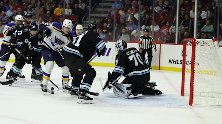 Sep 22, 2024; Des Moines, Iowa, USA; St. Louis Blues center Tanner Dickinson (78) shoots against Utah Hockey Club goaltender Karel Vejmelka (70) at Wells Fargo Arena. Mandatory Credit: Reese Strickland-Imagn Images

