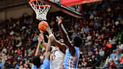 Mar 4, 2025; Blacksburg, Virginia, USA;  Virginia Tech Hokies guard Tyler Johnson (10) goes up for a shot as North Carolina Tar Heels forward Jalen Washington (13) defends during the first half at Cassell Coliseum. Mandatory Credit: Brian Bishop-Imagn Images