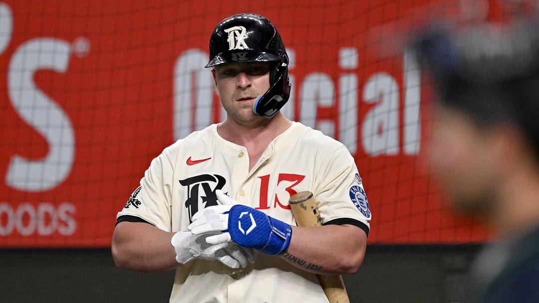 May 2, 2025; Arlington, Texas, USA; Texas Rangers first baseman Blaine Crim (13) looks on from the on deck circle before his first major league at bat during the third inning against the Seattle Mariners at Globe Life Field. Mandatory Credit: Jerome Miron-Imagn Images