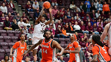 Mar 1, 2025; Blacksburg, Virginia, USA;  Virginia Tech Hokies guard Jaydon Young (3) looks to pass the ball against Syracuse Orange defenders during the second half at Cassell Coliseum. Mandatory Credit: Brian Bishop-Imagn Images