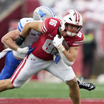 Sep 6, 2025; Madison, Wisconsin, USA;  Wisconsin Badgers tight end Lance Mason (86) runs the ball against Middle Tennessee Blue Raiders linebacker Parker Hughes (9) during the second half at Camp Randall Stadium