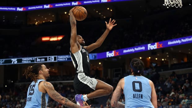 Apr 9, 2024; Memphis, Tennessee, USA; San Antonio Spurs guard Blake Wesley (14) drives to the basket for a dunk.