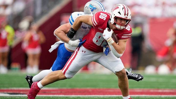 Sep 6, 2025; Madison, Wisconsin, USA;  Wisconsin Badgers tight end Lance Mason (86) runs the ball against Middle Tennessee Blue Raiders linebacker Parker Hughes (9) during the second half at Camp Randall Stadium. Mandatory Credit: Kayla Wolf-Imagn Images