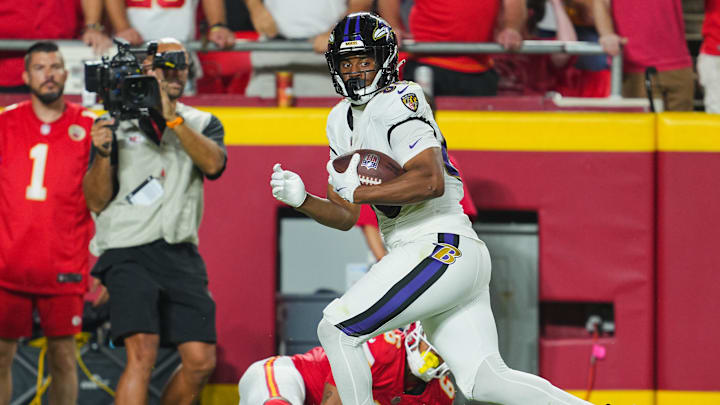 Sep 5, 2024; Kansas City, Missouri, USA; Baltimore Ravens tight end Isaiah Likely (80) scores a touchdown against Kansas City Chiefs safety Bryan Cook (6) during the second half at GEHA Field at Arrowhead Stadium. Mandatory Credit: Jay Biggerstaff-Imagn Images