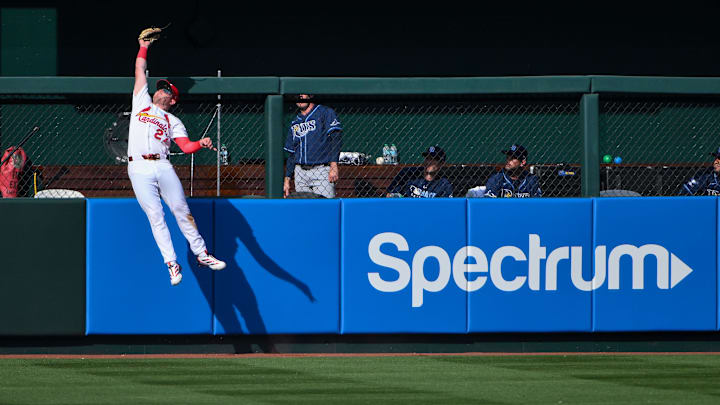 Mar 26, 2026; St. Louis, Missouri, USA; St. Louis Cardinals left fielder Nathan Church (27) leaps at the wall and robs a home run from Tampa Bay Rays left fielder Ryan Vilade (not pictured) during the fifth inning at Busch Stadium. Mandatory Credit: Jeff Curry-Imagn Images