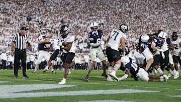 Sep 27, 2025; University Park, Pennsylvania, USA; Oregon Ducks running back Jordon Davison (0) scores a touchdown during the third quarter against the Penn State Nittany Lions at Beaver Stadium. Mandatory Credit: Matthew O'Haren-Imagn Images