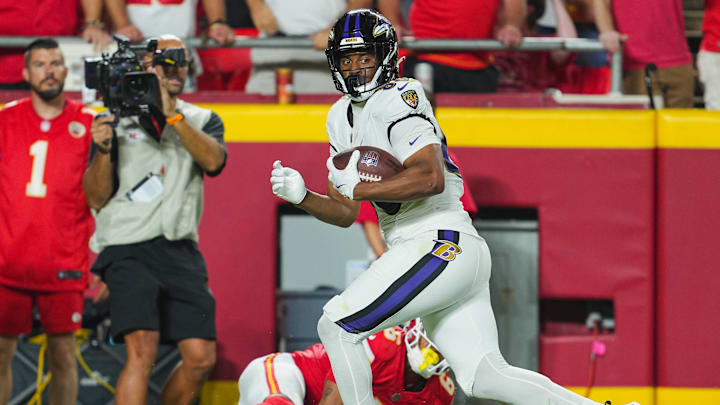 Sep 5, 2024; Kansas City, Missouri, USA; Baltimore Ravens tight end Isaiah Likely (80) scores a touchdown against Kansas City Chiefs safety Bryan Cook (6) during the second half at GEHA Field at Arrowhead Stadium. Mandatory Credit: Jay Biggerstaff-Imagn Images