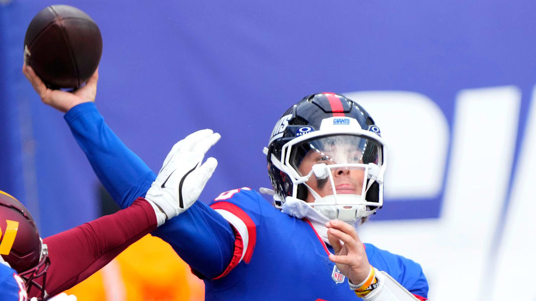 New York Giants quarterback Jaxson Dart (6) throws a pass through strong Washington defense, Sunday, December 14, 2025.