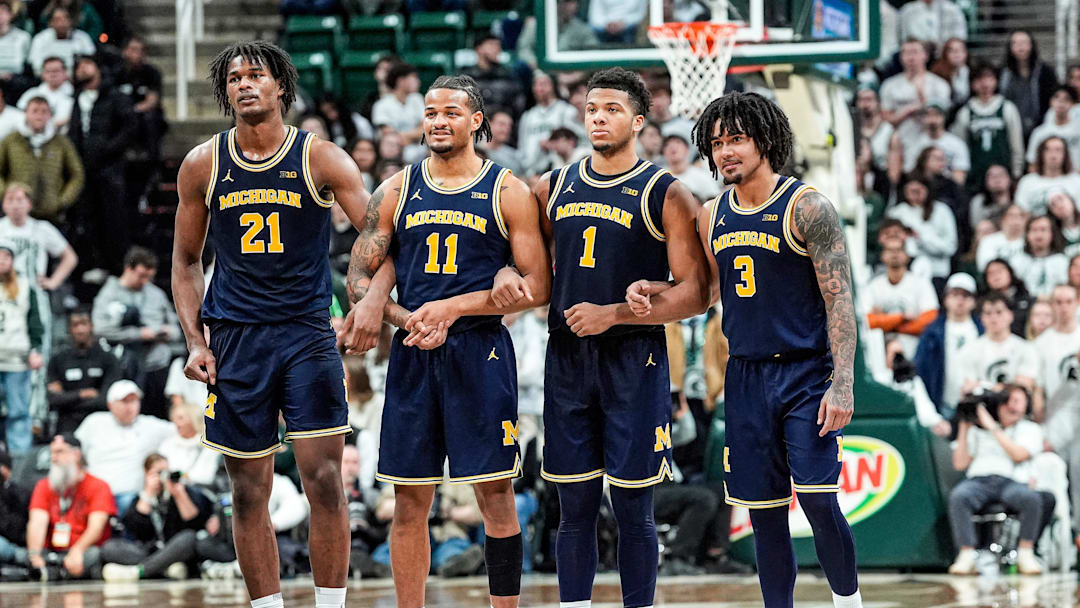 From left, Michigan forward Morez Johnson Jr. (21), guard Roddy Gayle Jr. (11), guard Trey McKenney (1) and guard Elliot Cadeau (3) locks arms to watch forward Yaxel Lendeborg (not in the photo) shoot free throw against Michigan State during the second half at Breslin Center in East Lansing on Friday, Jan. 30, 2026.