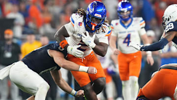 Dec 31, 2024; Glendale, AZ, US; Boise State Broncos running back Ashton Jeanty (2) tries to break past Penn State Nittany Lions linebacker Dominic DeLuca (0) during their Vrbo Fiesta Bowl matchup at State Farm Stadium.