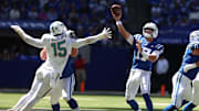 Sep 7, 2025; Indianapolis, Indiana, USA; Indianapolis Colts quarterback Daniel Jones (17) throws a touchdown against Miami Dolphins linebacker Jaelan Phillips (15) during the first half at Lucas Oil Stadium. Mandatory Credit: Trevor Ruszkowski-Imagn Images
