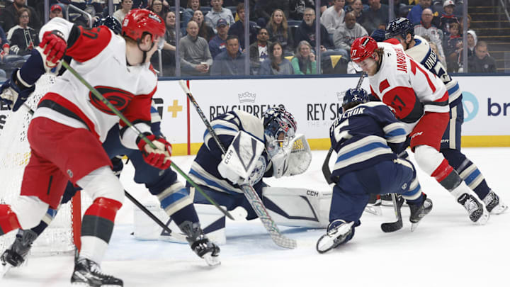 Mar 31, 2026; Columbus, Ohio, USA; Columbus Blue Jackets goalie Jet Greaves (73) makes a save as Carolina Hurricanes center Mark Jankowski (77) looks for a rebound during the first period at Nationwide Arena. Mandatory Credit: Russell LaBounty-Imagn Images