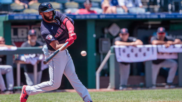 Amed Rosario swings and hits the ball 