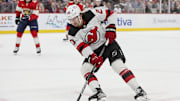 Jan 13, 2024; Sunrise, Florida, USA; New Jersey Devils center Michael McLeod (20) moves the puck against the Florida Panthers during the first period at Amerant Bank Arena. Mandatory Credit: Sam Navarro-Imagn Images