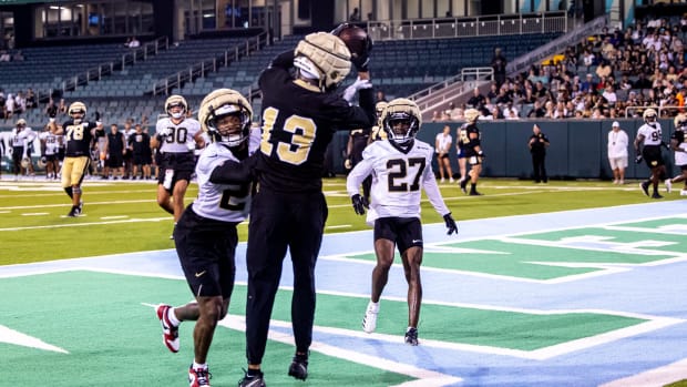 New Orleans Saints receiver Equanimeous St. Brown (13) scores a touchdown against safety Johnathan Abram (24) during practice