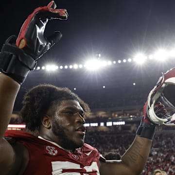 Nov 4, 2023; Tuscaloosa, Alabama, USA; Alabama Crimson Tide offensive lineman Tyler Booker (52) celebrates after defeating the LSU Tigers during the second half at Bryant-Denny Stadium. Mandatory Credit: Butch Dill-Imagn Images